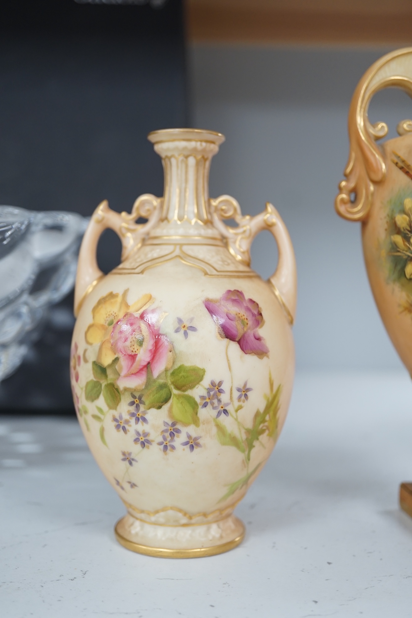 Three pieces of Royal Worcester; a mug, 11.5cm high, and two vases, tallest 22.5cm. Condition - good.